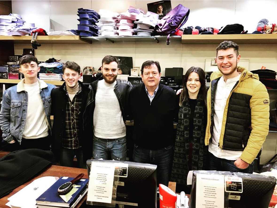 The Barry's Menswear team gathered at the shop counter
