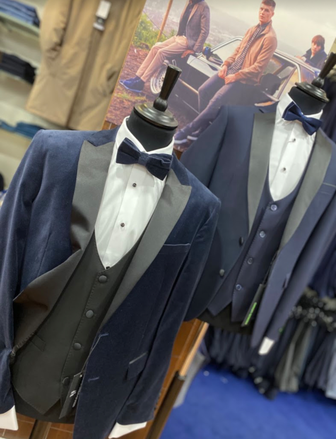 Navy dinner suits with waistcoats and bow ties on the hire rail in Barry's Menswear
