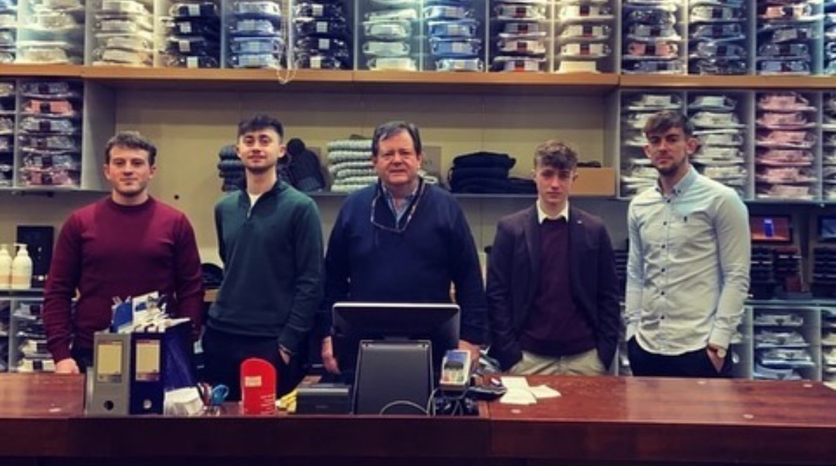 Members of staff standing together behind the shop counter