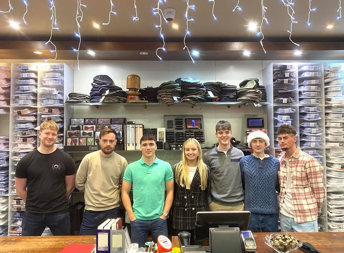 The full team under the Christmas lights in Barry's Menswear